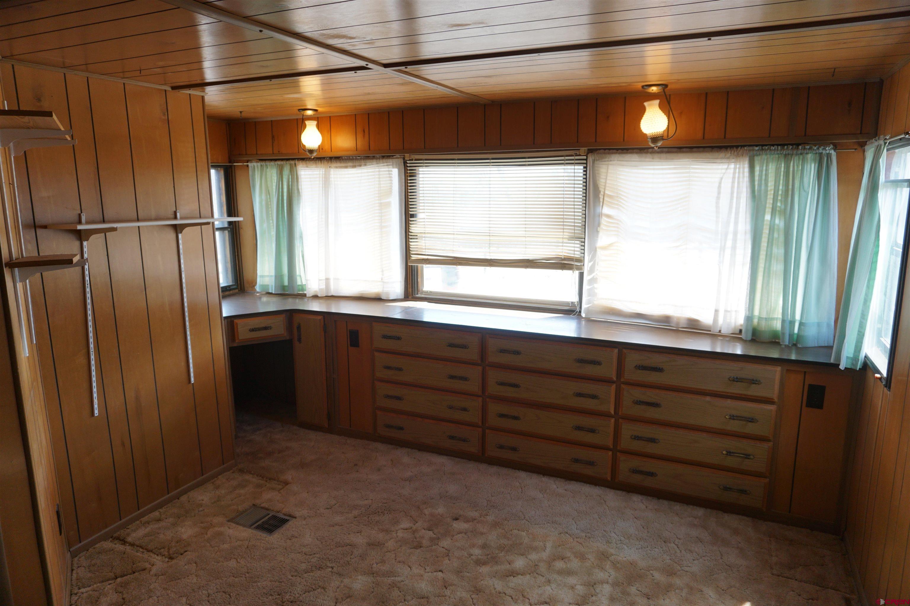 60497 Maple Grove Road Montrose, CO 81403 - Photo 8 of 16 a bathroom with a sink window and mirror