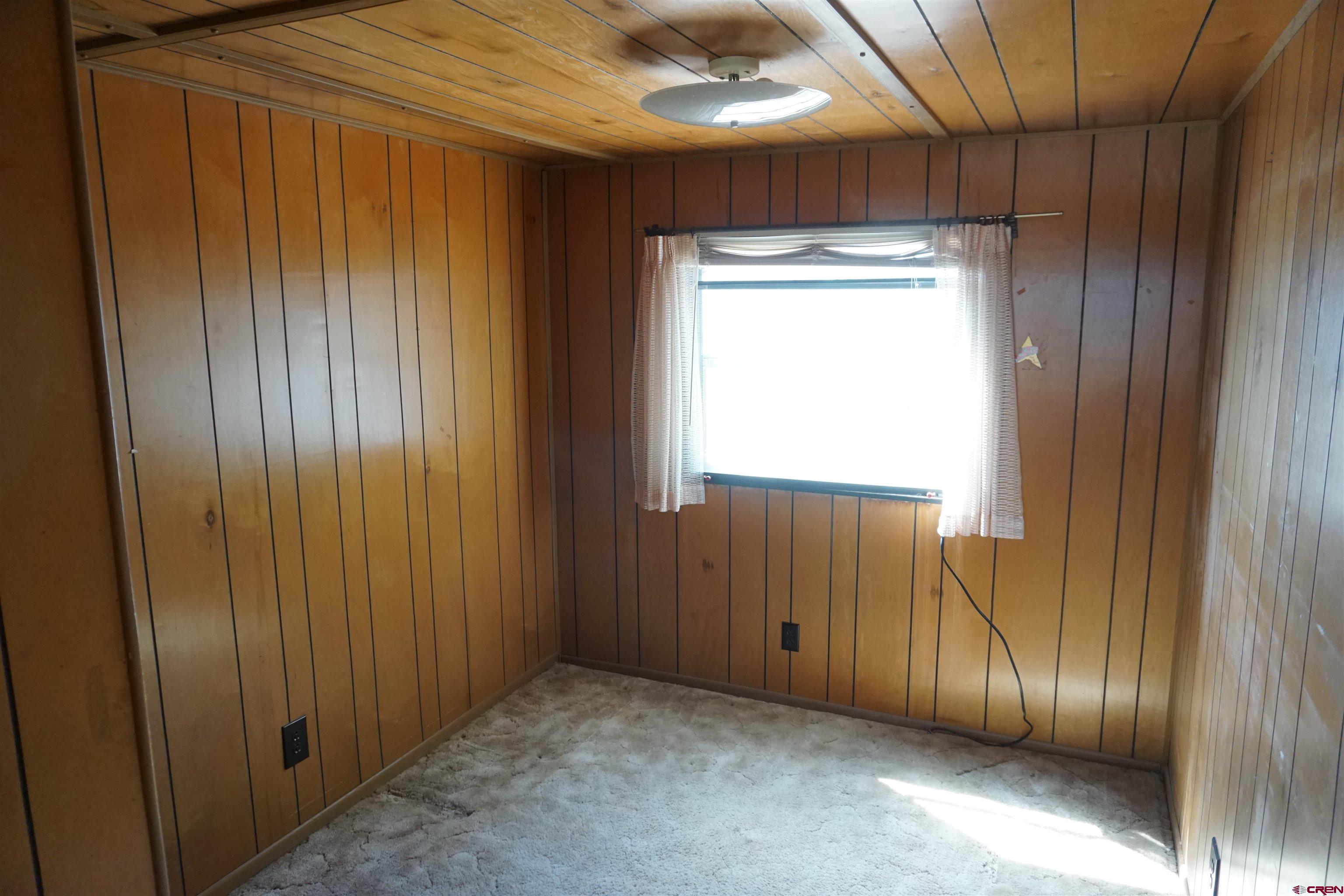 60497 Maple Grove Road Montrose, CO 81403 - Photo 9 of 16 a view of an empty room with wooden floor