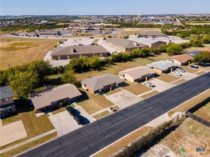 an aerial view of residential houses with outdoor space