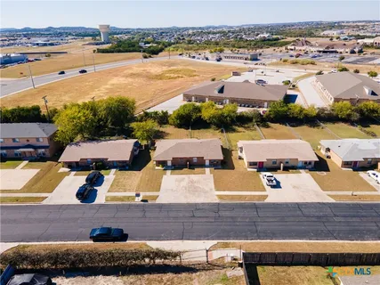 an aerial view of residential houses with outdoor space