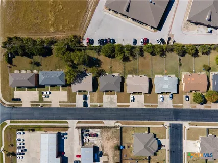 an aerial view of multiple houses with outdoor space