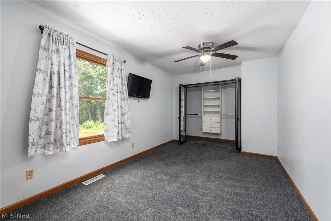 9990 Broadview Road Broadview Heights, OH 44147 - Photo 21 of 47 Unfurnished bedroom with carpet floors, ceiling fan, and a textured ceiling