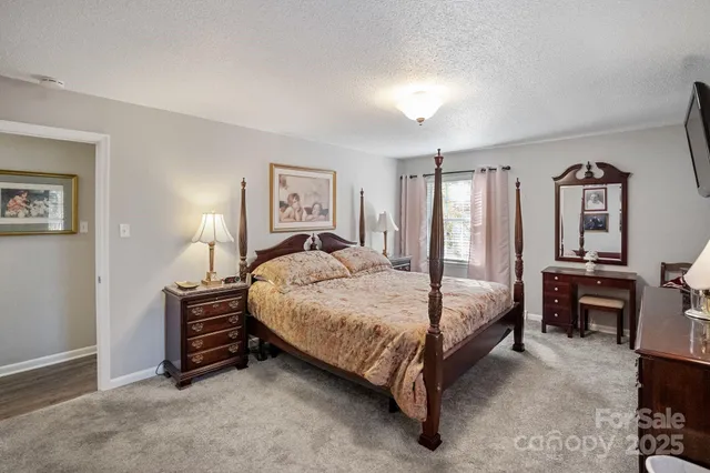 a bedroom with a bed dresser and a chair