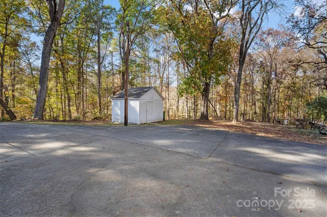 a view of dirt field and trees
