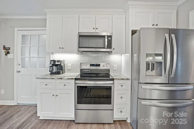 a kitchen with cabinets and stainless steel appliances