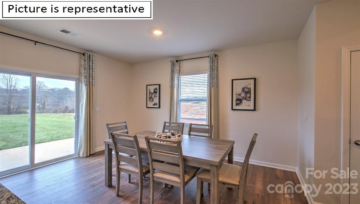 2164 Vanderlyn Street Monroe, NC 28112 - Photo 19 of 37 a view of a dining room with furniture and wooden floor