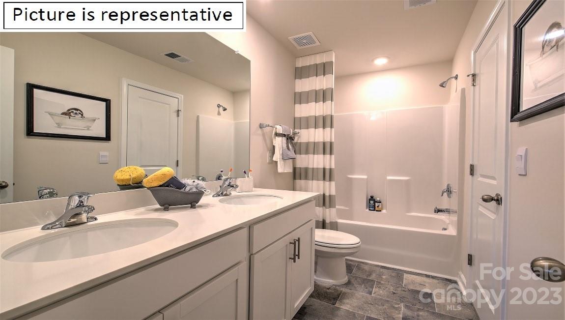 2164 Vanderlyn Street Monroe, NC 28112 - Photo 36 of 37 a bathroom with a granite countertop sink toilet and shower