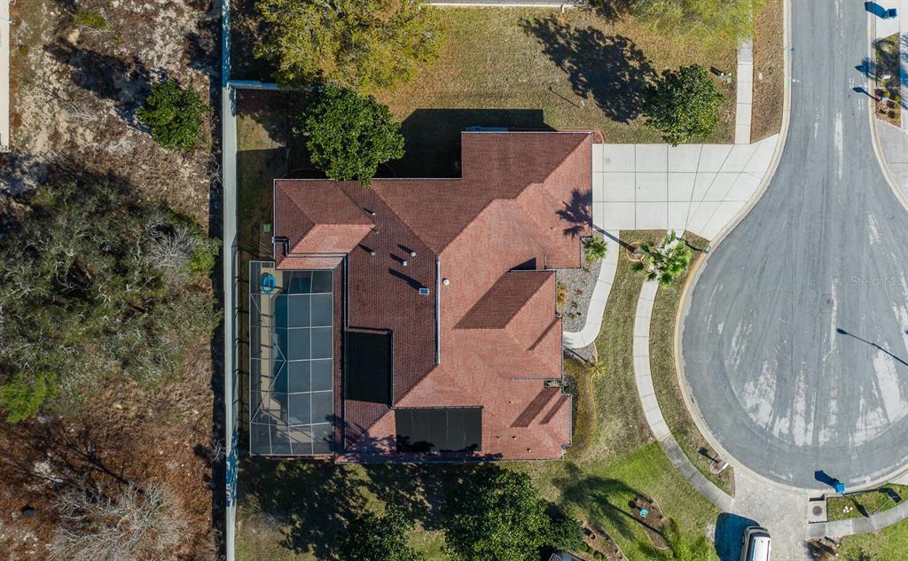 427 Archway Drive Spring Hill, FL 34608 - Photo 11 of 68 an aerial view of a house with swimming pool and trees