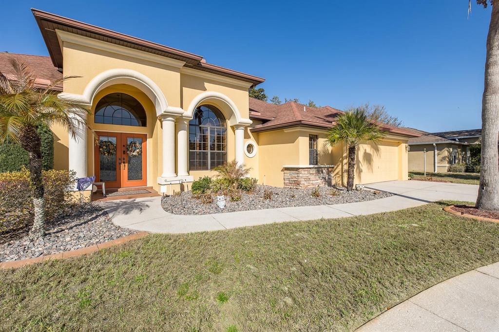 427 Archway Drive Spring Hill, FL 34608 - Photo 12 of 68 a view of a house with large windows and a yard