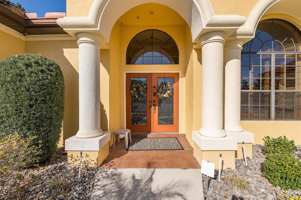 427 Archway Drive Spring Hill, FL 34608 - Photo 14 of 68 a front view of a house with a garden