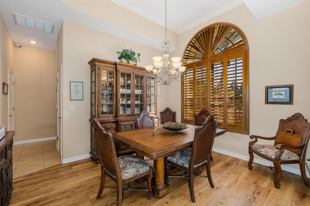 427 Archway Drive Spring Hill, FL 34608 - Photo 16 of 68 a view of a dining room with furniture and wooden floor