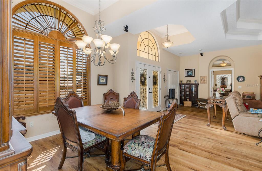 427 Archway Drive Spring Hill, FL 34608 - Photo 17 of 68 a view of a dining room with furniture and wooden floor