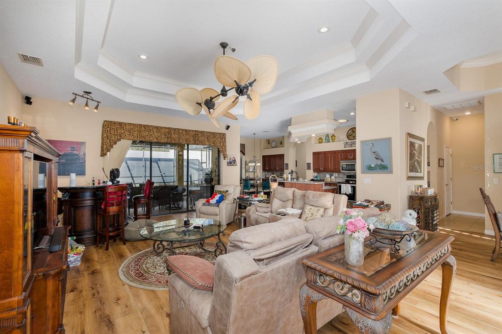 427 Archway Drive Spring Hill, FL 34608 - Photo 19 of 68 a living room with lots of furniture and chandelier