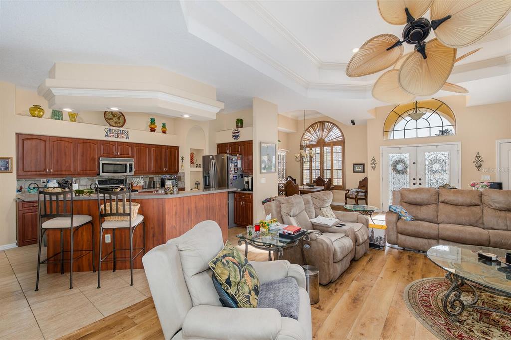 427 Archway Drive Spring Hill, FL 34608 - Photo 20 of 68 a living room with furniture a rug and a chandelier
