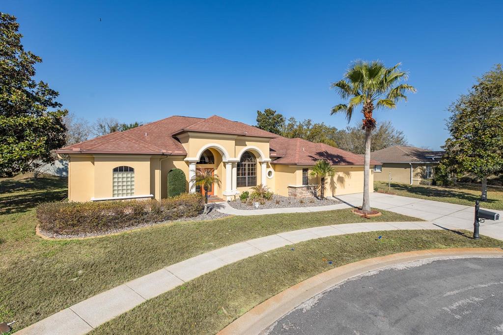 427 Archway Drive Spring Hill, FL 34608 - Photo 2 of 68 a front view of a house with a yard