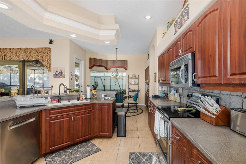 427 Archway Drive Spring Hill, FL 34608 - Photo 23 of 68 a kitchen with lots of counter top space and wooden floor