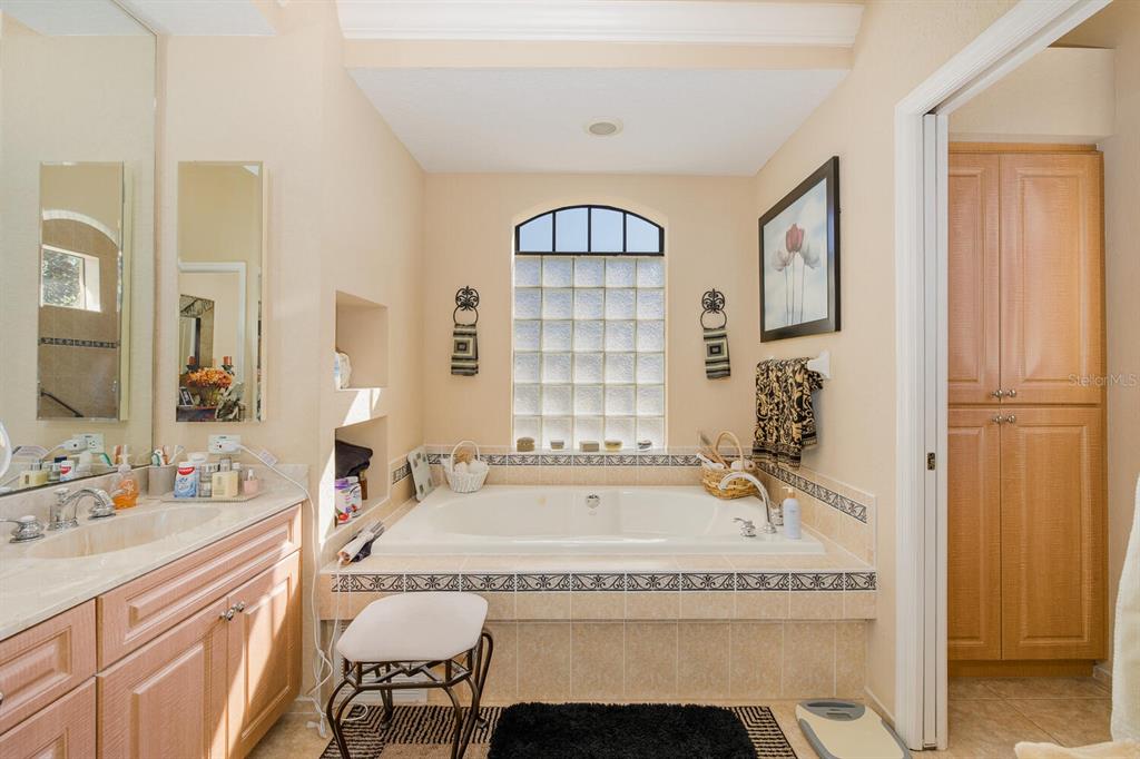 427 Archway Drive Spring Hill, FL 34608 - Photo 33 of 68 a bathroom with a tub sink and mirror