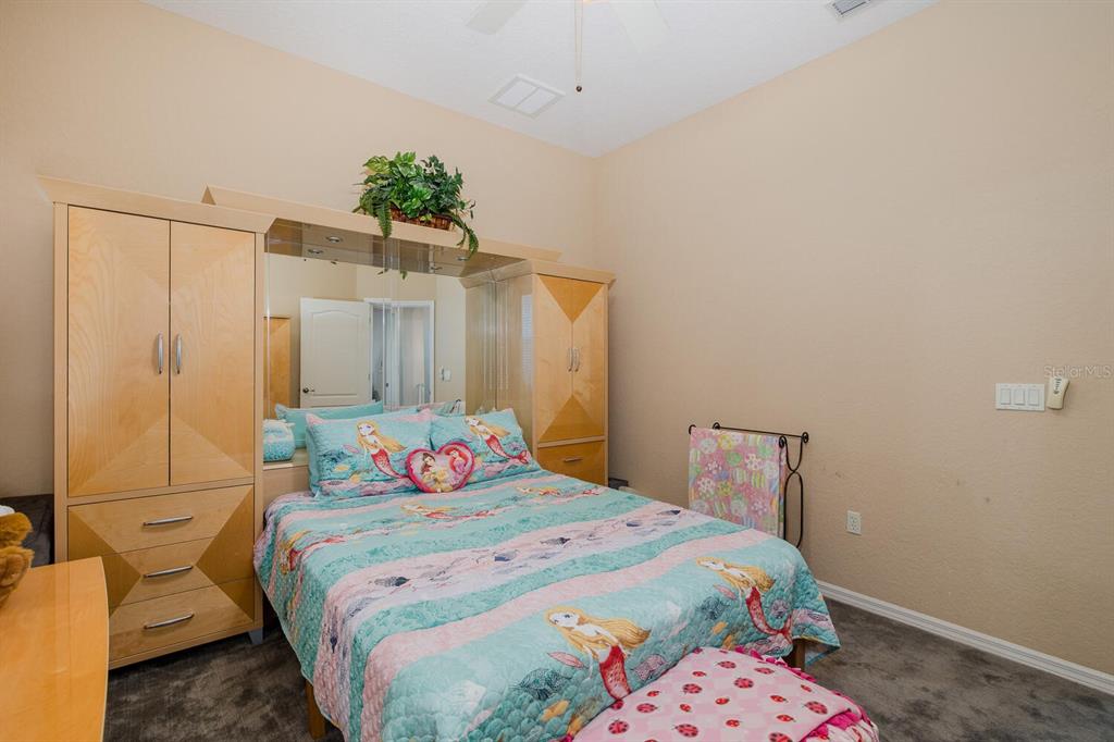 427 Archway Drive Spring Hill, FL 34608 - Photo 38 of 68 a bedroom with a bed and a mirror