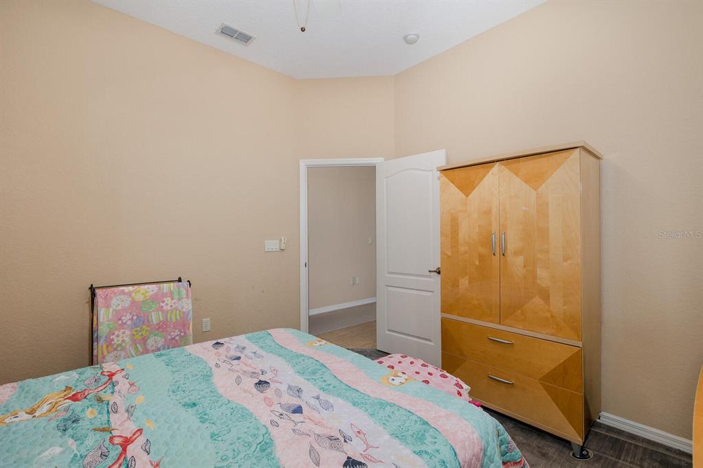 427 Archway Drive Spring Hill, FL 34608 - Photo 39 of 68 a bedroom with a bed and a window