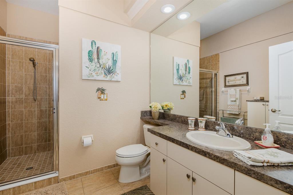 427 Archway Drive Spring Hill, FL 34608 - Photo 40 of 68 a bathroom with a granite countertop sink a toilet and shower