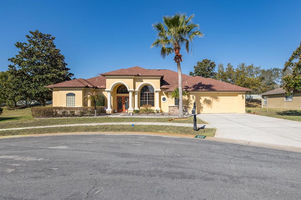 427 Archway Drive Spring Hill, FL 34608 - Photo 4 of 68 a front view of a house with a yard and garage