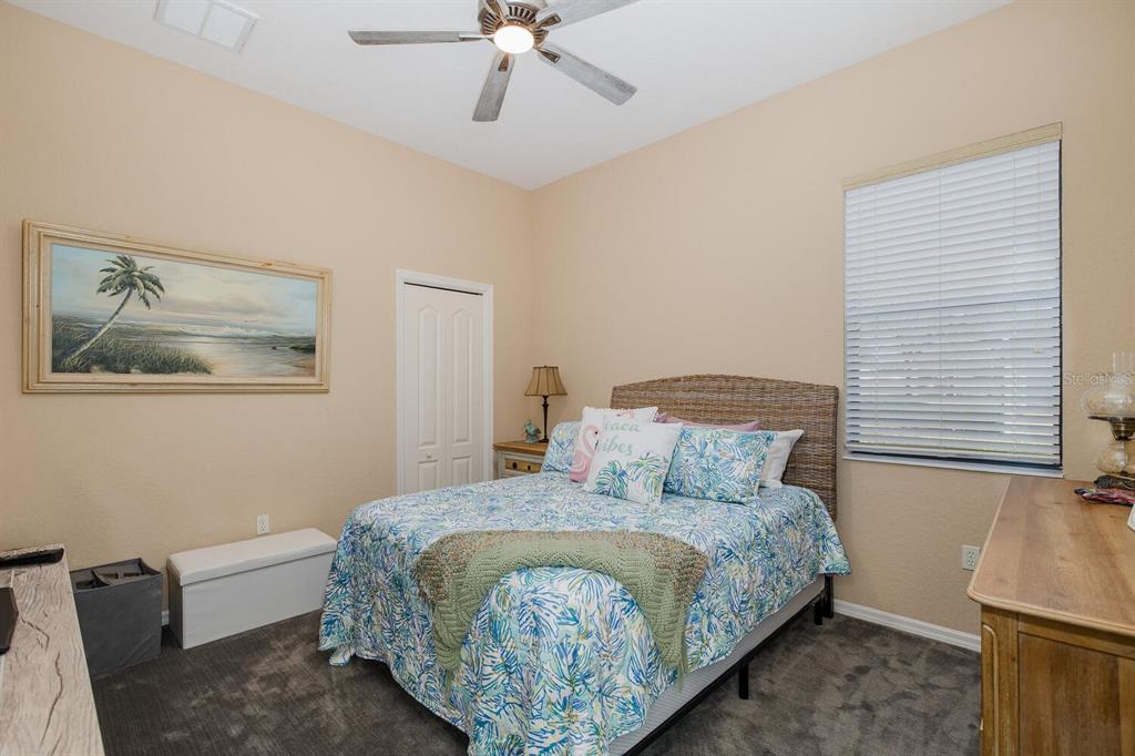 427 Archway Drive Spring Hill, FL 34608 - Photo 43 of 68 a bedroom with a bed and painting on the wall