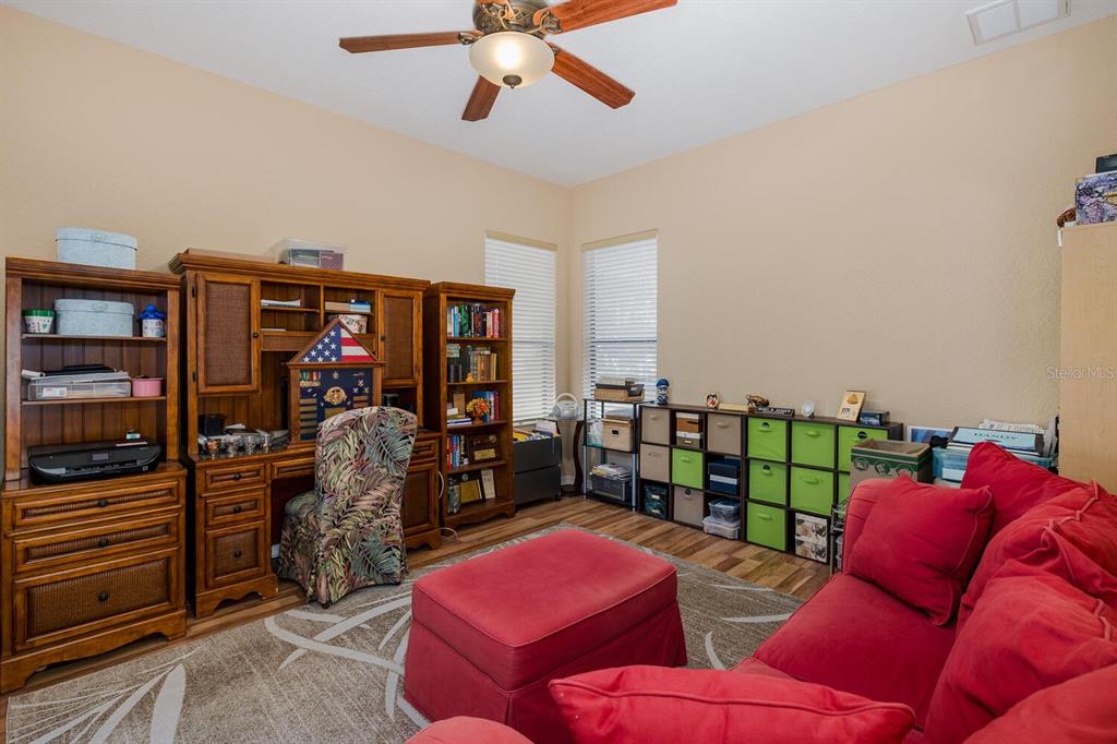 427 Archway Drive Spring Hill, FL 34608 - Photo 45 of 68 a living room with furniture a ceiling fan and a rug