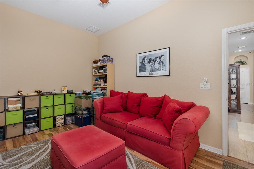 427 Archway Drive Spring Hill, FL 34608 - Photo 47 of 68 a blue couch sitting in a living room with furniture