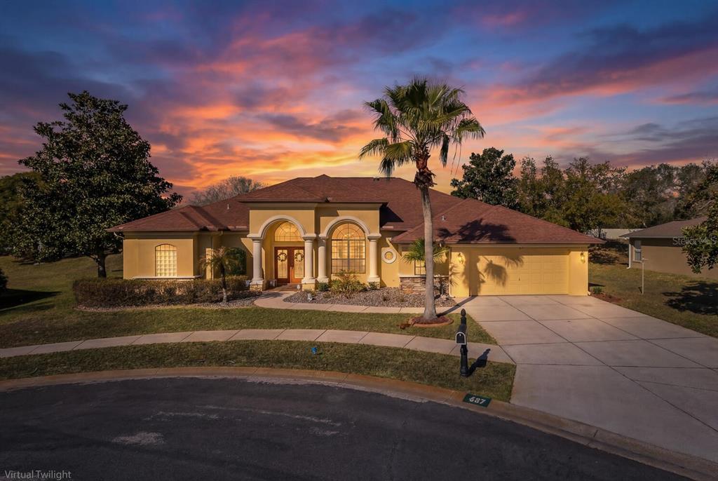 427 Archway Drive Spring Hill, FL 34608 - Photo 5 of 68 a front view of a house with a yard