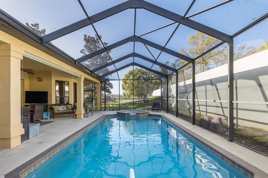 427 Archway Drive Spring Hill, FL 34608 - Photo 57 of 68 a view of a living room and kitchen with a large window