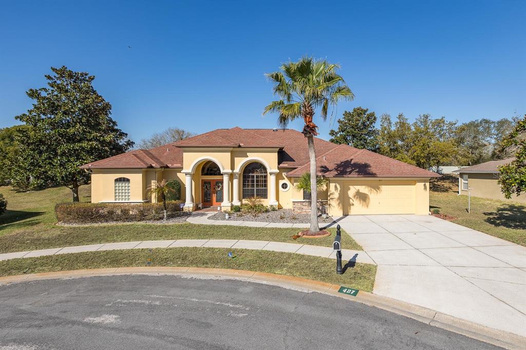427 Archway Drive Spring Hill, FL 34608 - Photo 6 of 68 a front view of a house with a yard and garage