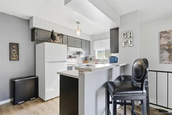 a kitchen with stainless steel appliances a refrigerator and a stove top oven