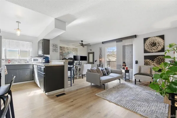 a living room with furniture kitchen and a window