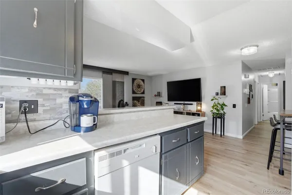 a kitchen with a sink and a refrigerator