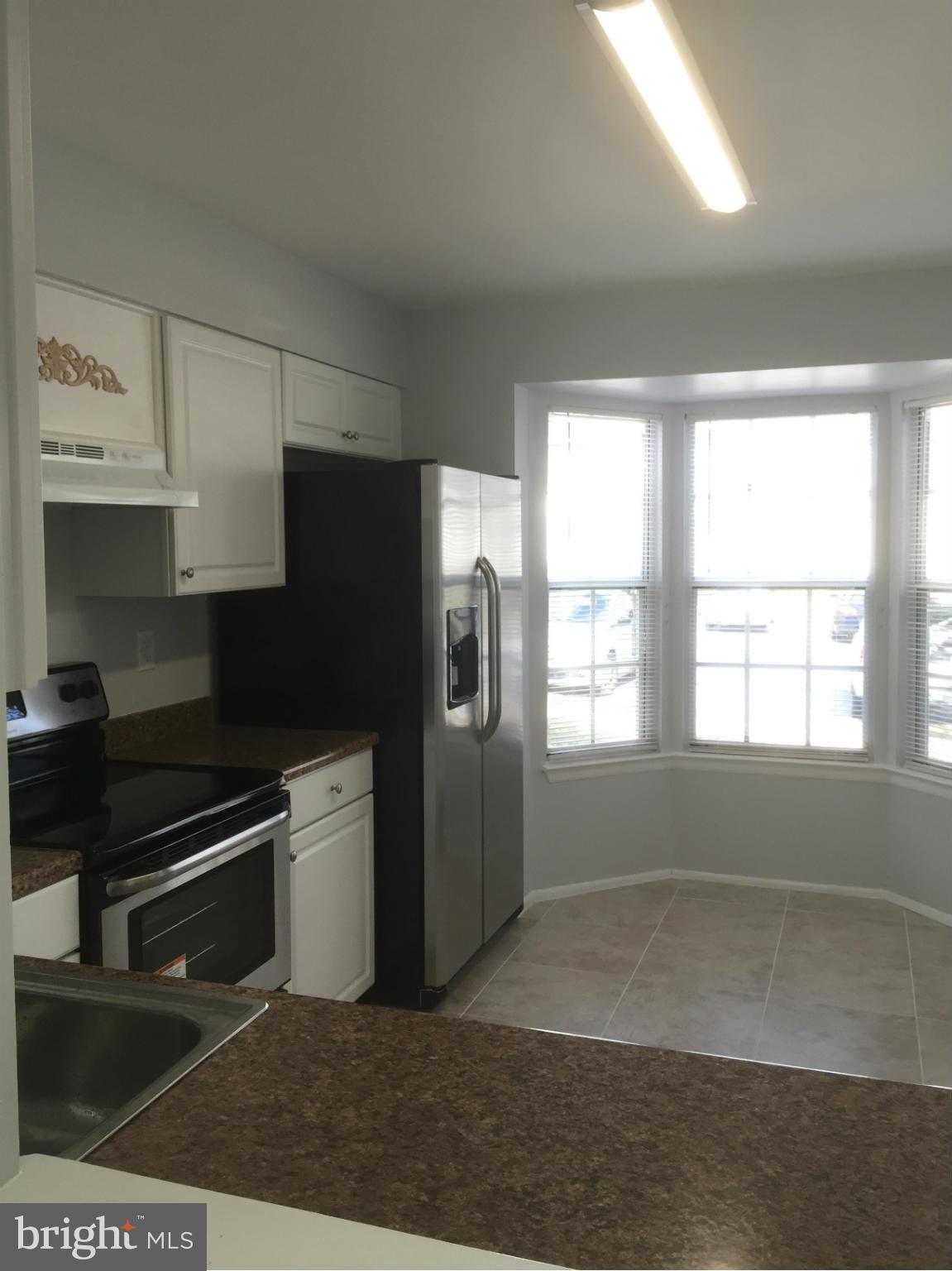 6965 Rockfield Road Baltimore, MD 21244 - Photo 14 of 18 a kitchen with stainless steel appliances a refrigerator and a stove