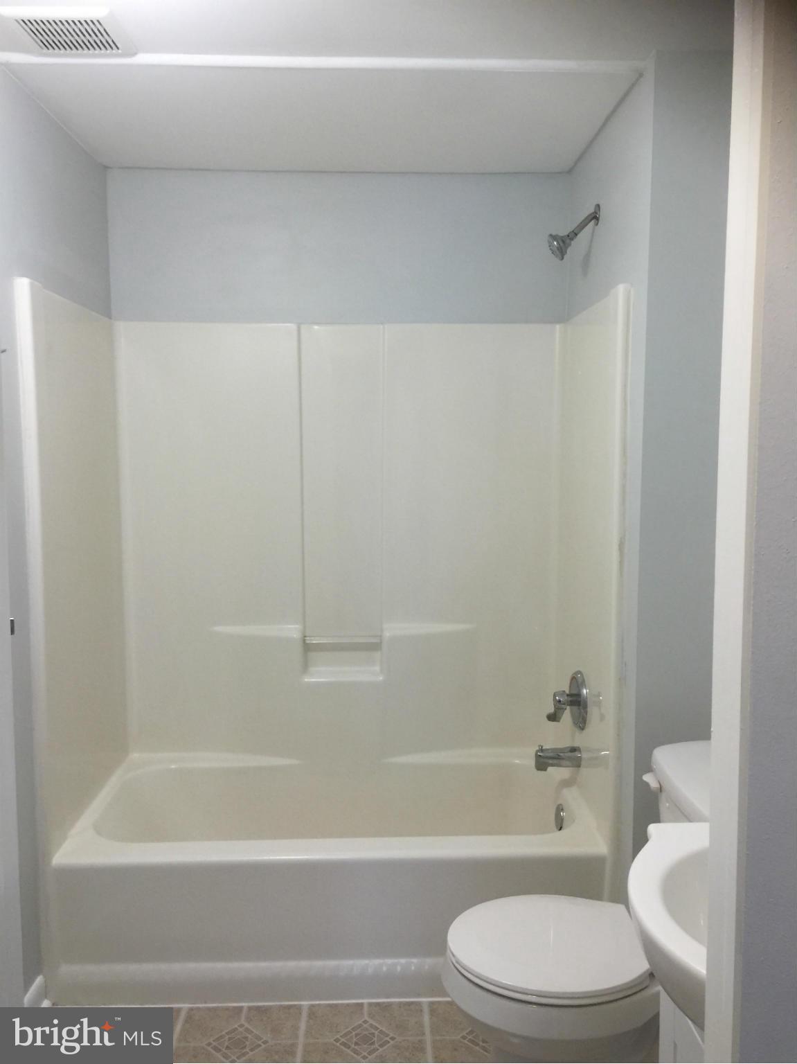6965 Rockfield Road Baltimore, MD 21244 - Photo 10 of 18 a bathroom with a toilet and a bath tub