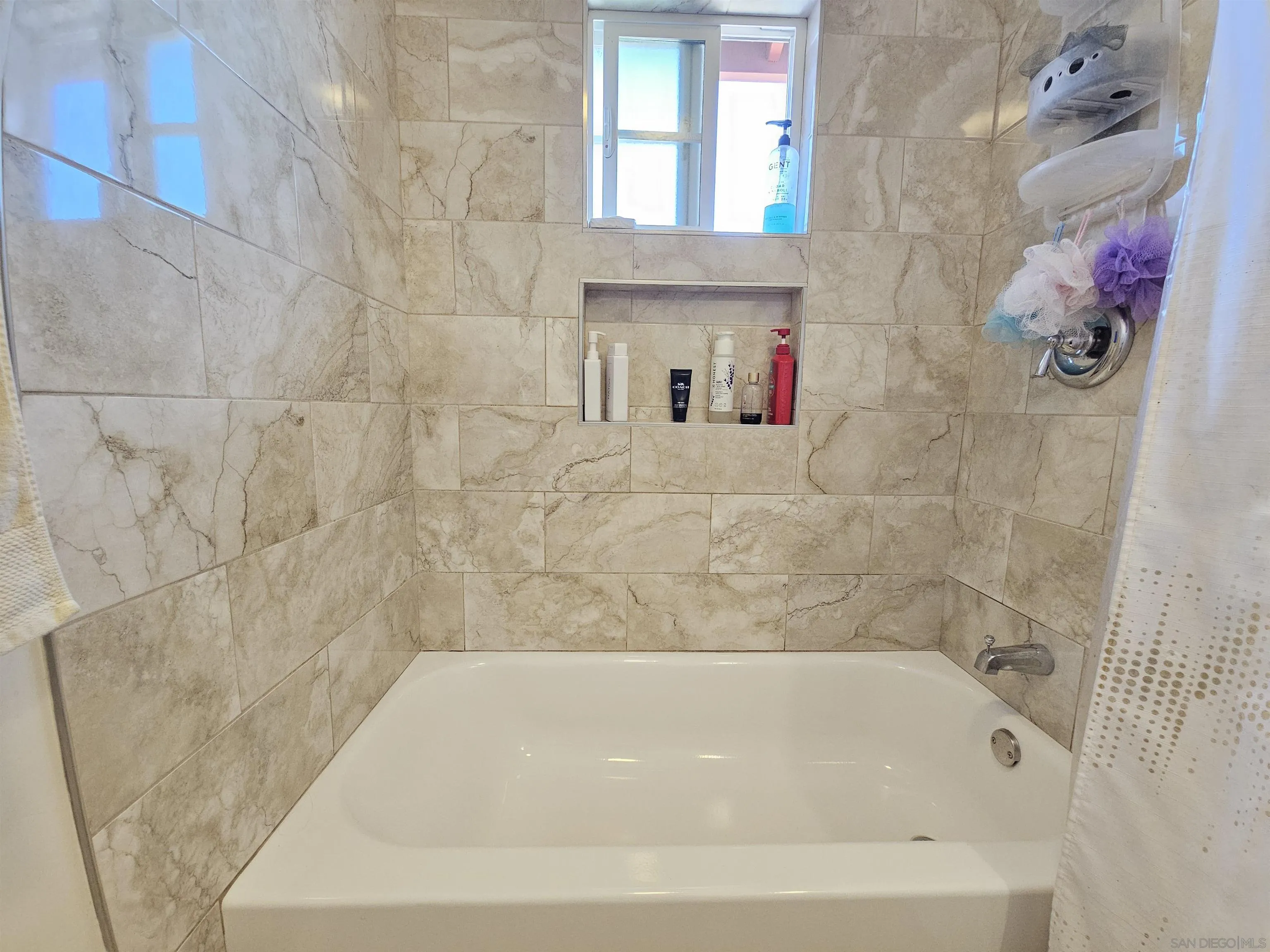 1621 Jade Avenue Chula Vista, CA 91911 - Photo 14 of 19 a bath tub sitting next to a white bathroom sink and a shower