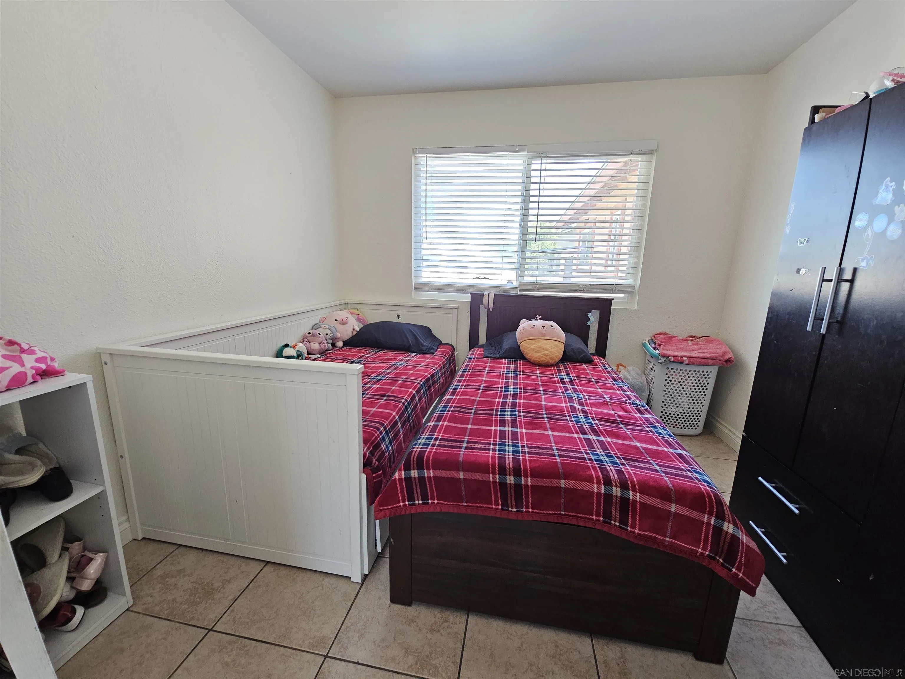 1621 Jade Avenue Chula Vista, CA 91911 - Photo 18 of 19 a bedroom with a bed a dresser and a window