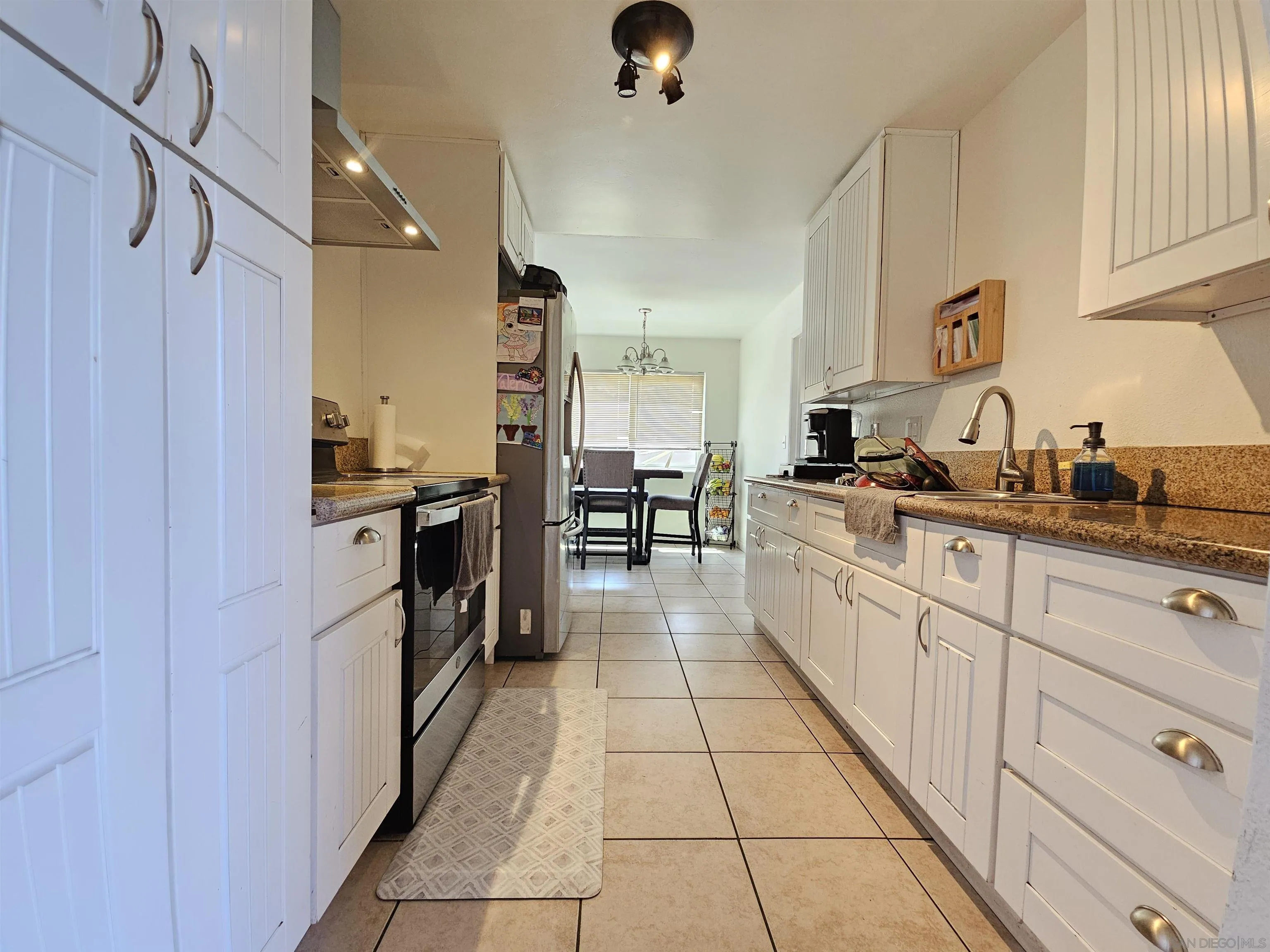 1621 Jade Avenue Chula Vista, CA 91911 - Photo 2 of 19 a large kitchen with white cabinets