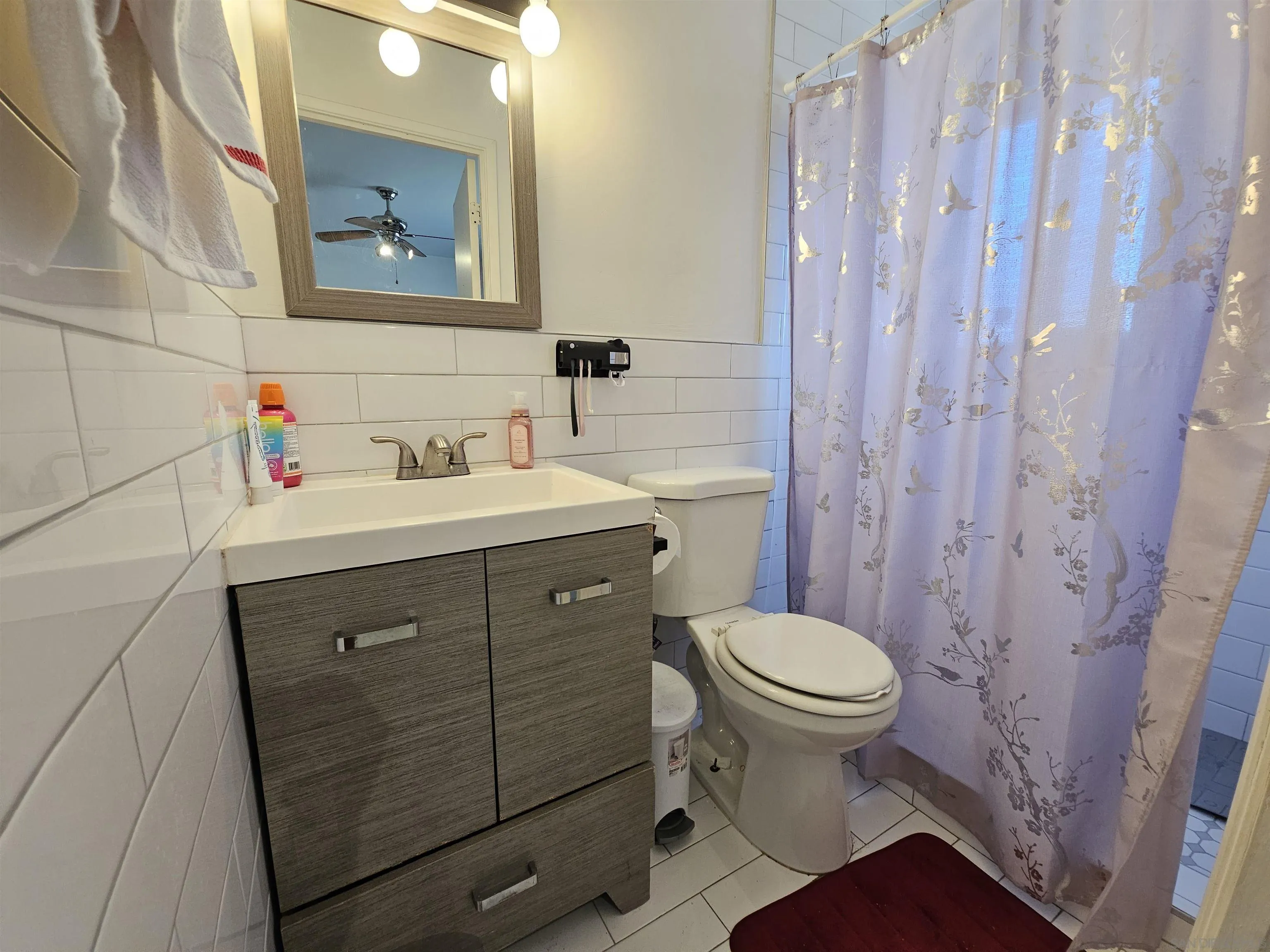 1621 Jade Avenue Chula Vista, CA 91911 - Photo 10 of 19 a bathroom with a sink toilet and a mirror