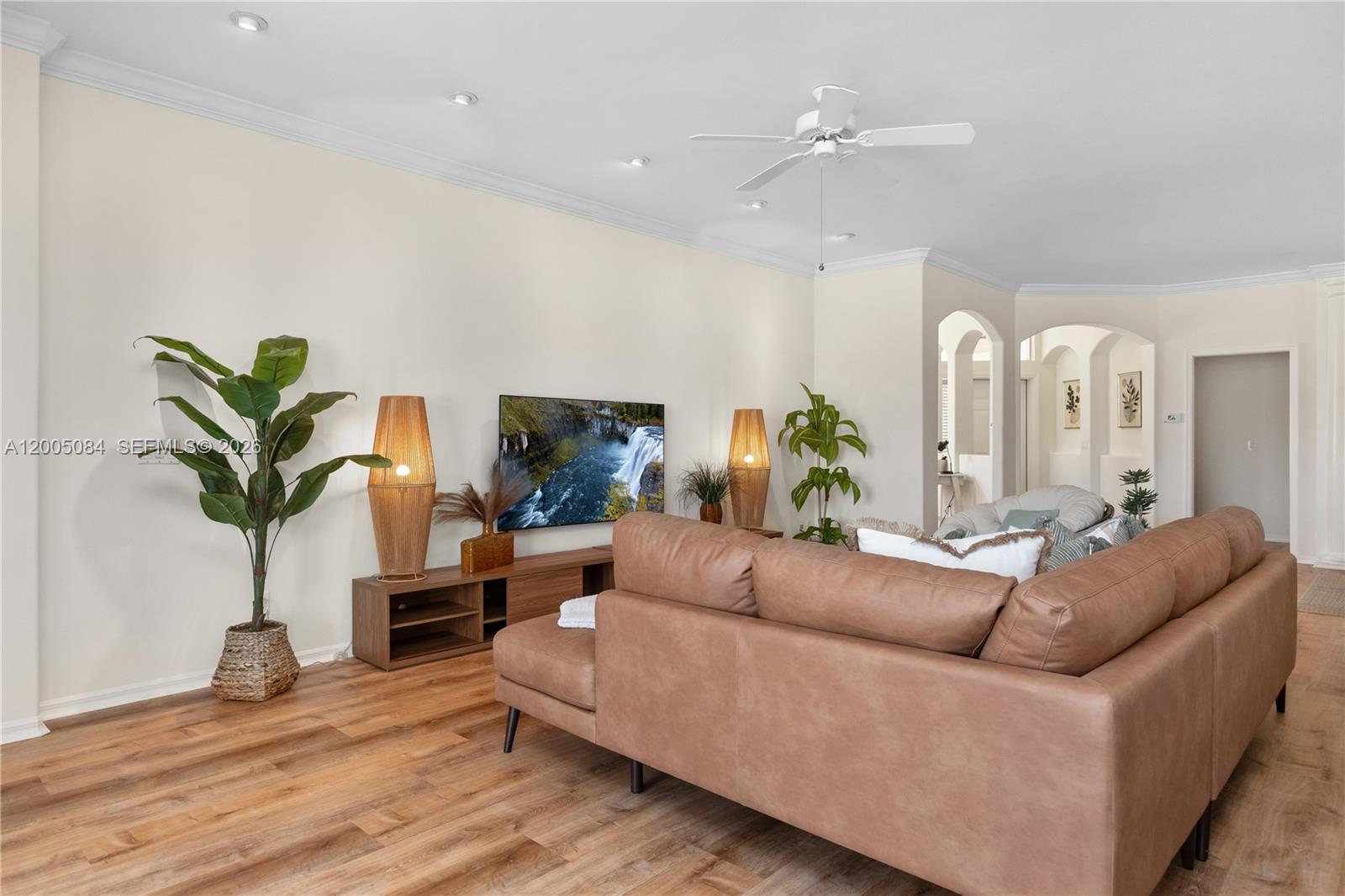 1896 Crestview Way Naples, FL 34119 - Photo 13 of 91 a living room with furniture potted plant and a window