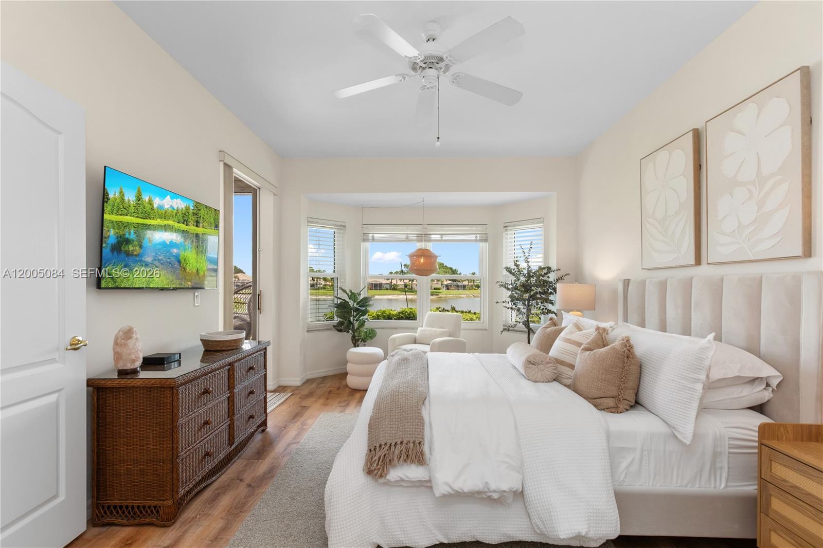 1896 Crestview Way Naples, FL 34119 - Photo 51 of 91 a living room with furniture a flat screen tv and a chandelier