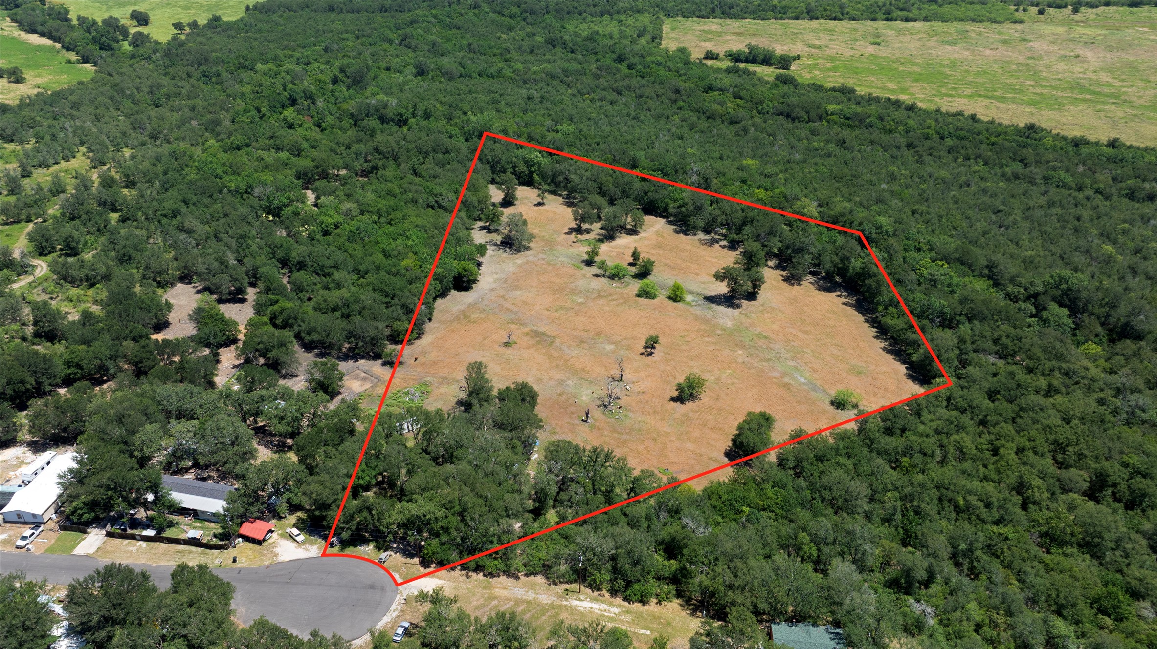 23318 Ingram Drive Elgin, TX 78621 - Photo 1 of 4 Vast, undeveloped land offering abundant trees and natural privacy for future endeavors.