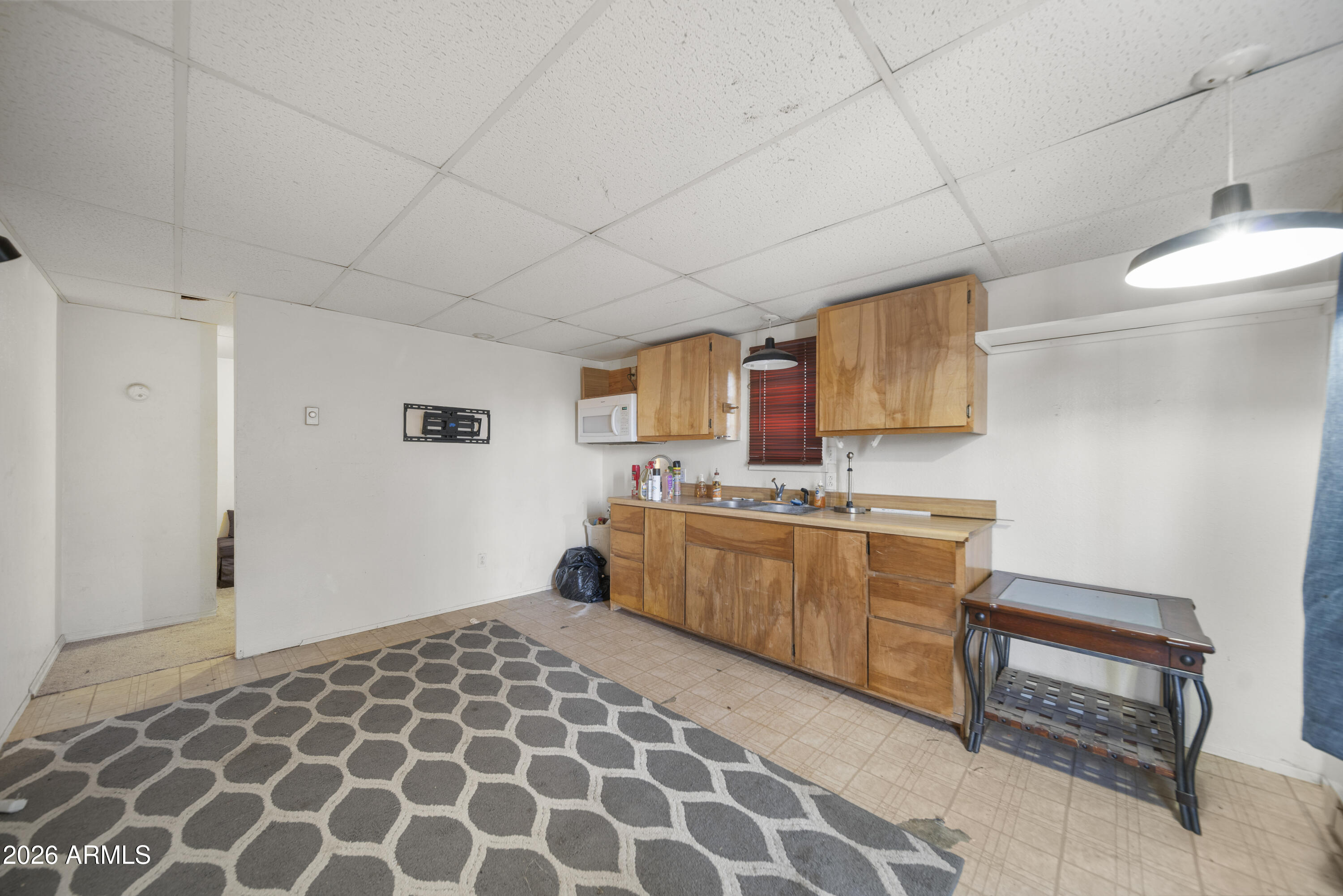 26162 Pecks Peak Road Kirkland, AZ 86332 - Photo 24 of 51 a kitchen with a sink a stove cabinets and a window