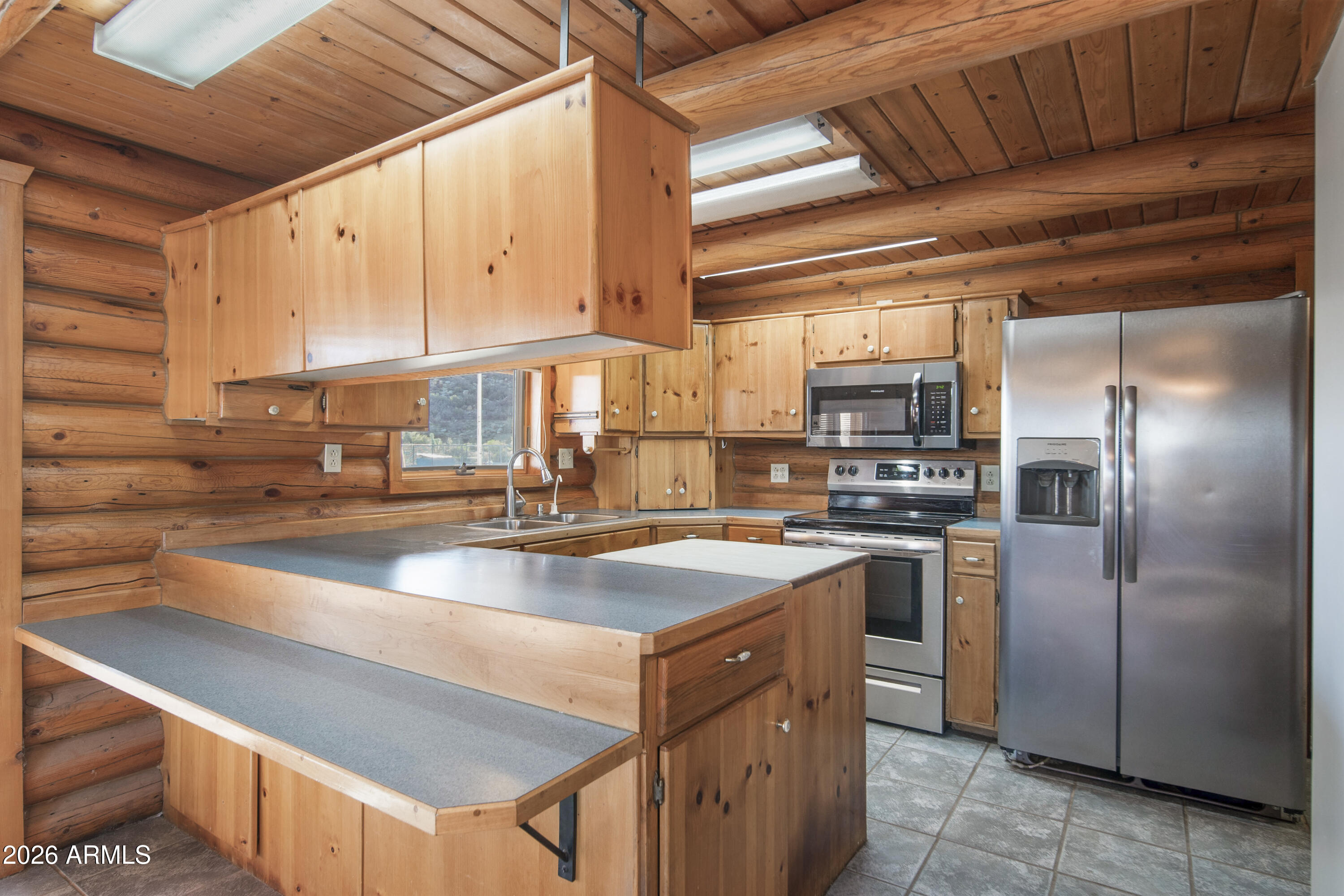 26162 Pecks Peak Road Kirkland, AZ 86332 - Photo 3 of 51 a kitchen with stainless steel appliances granite countertop a sink a stove and a refrigerator