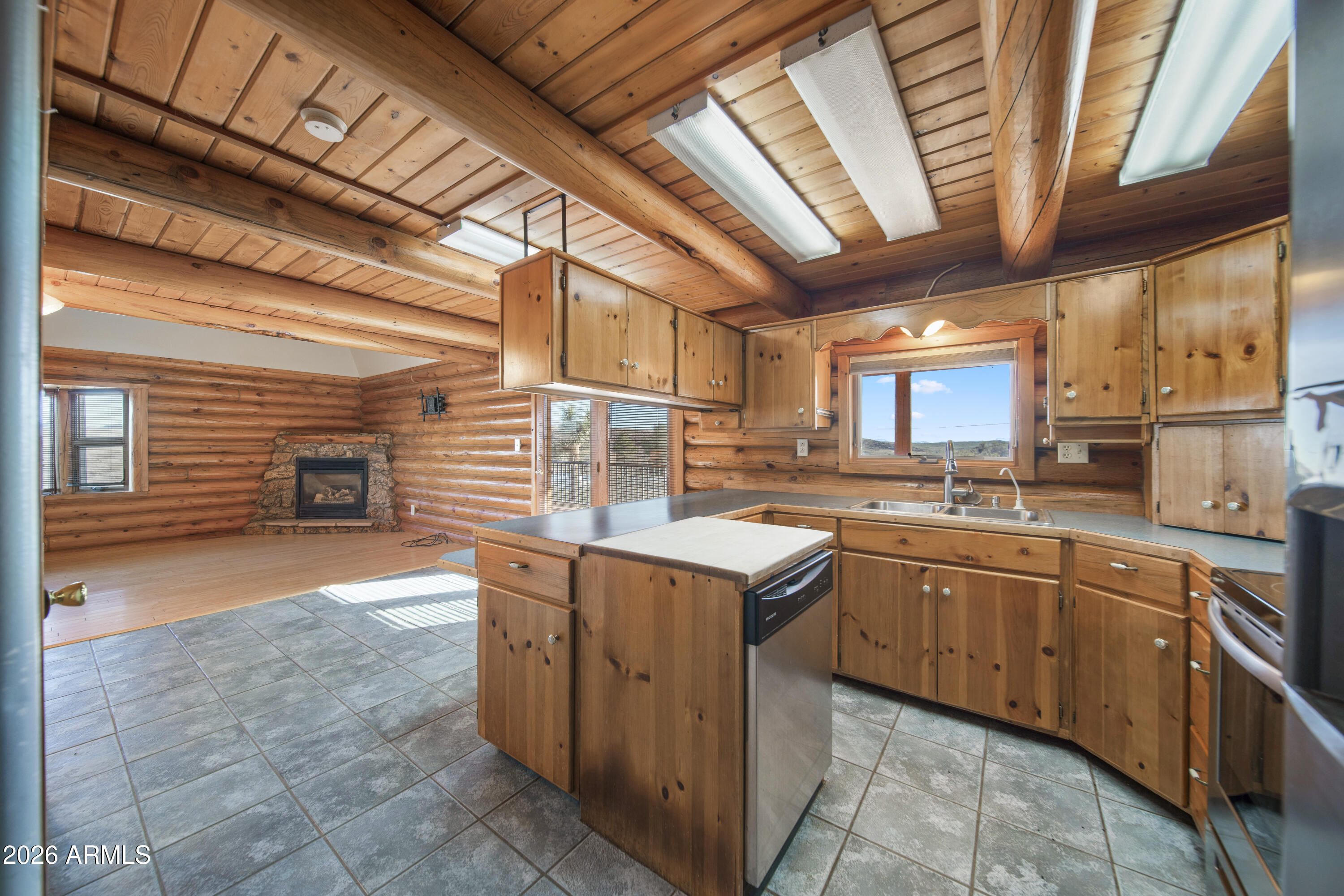 26162 Pecks Peak Road Kirkland, AZ 86332 - Photo 7 of 51 a kitchen with stainless steel appliances granite countertop a sink counter space cabinets and a window