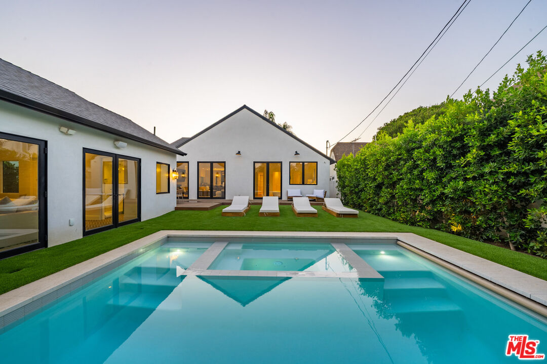 a view of an house with swimming pool yard and porch