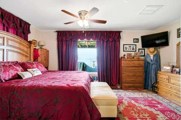 a bedroom with a bed and a flat screen tv