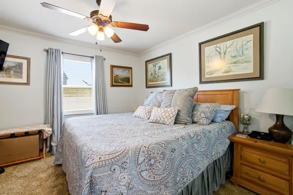 a bedroom with a large bed and a chandelier