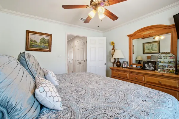 a bedroom with a bed and a chandelier